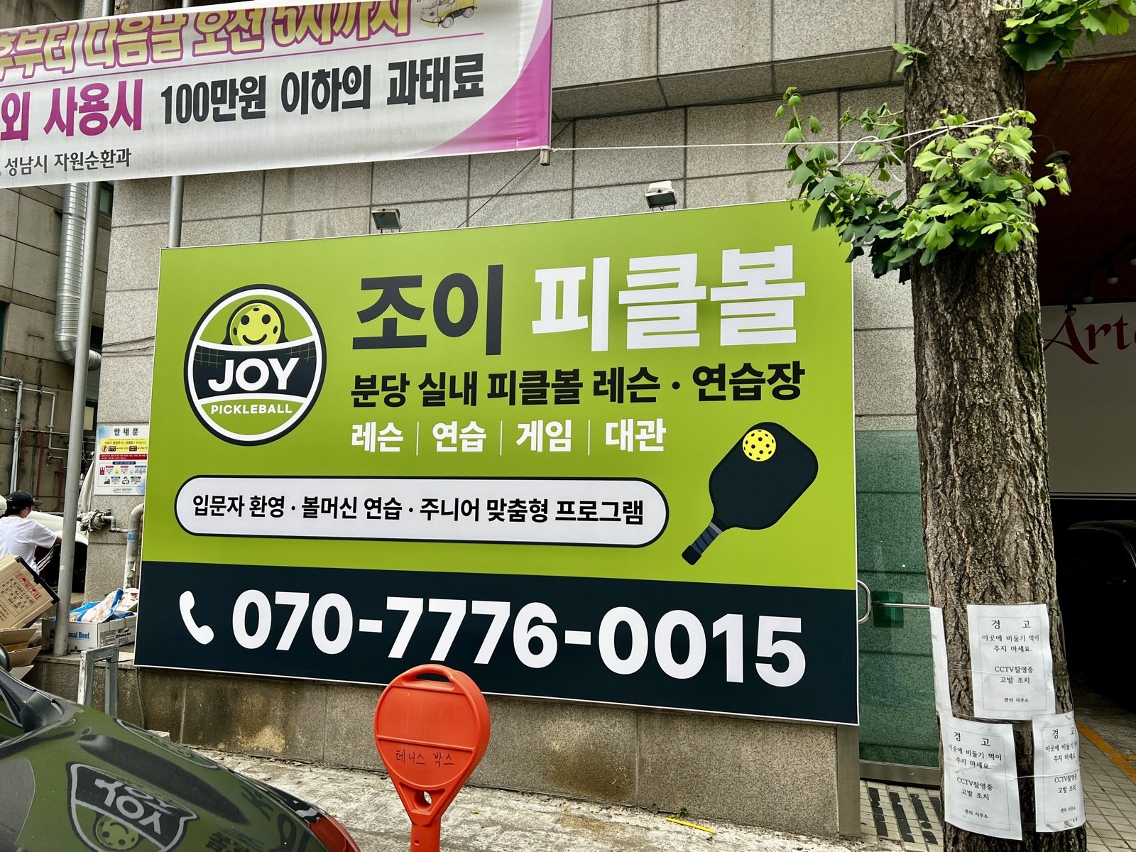 건물 외부의 초록색 조이 피클볼 간판